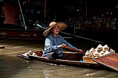 Thailand, Locals sell fruits, food and products at Damnoen Saduak floating market near Bangkok 